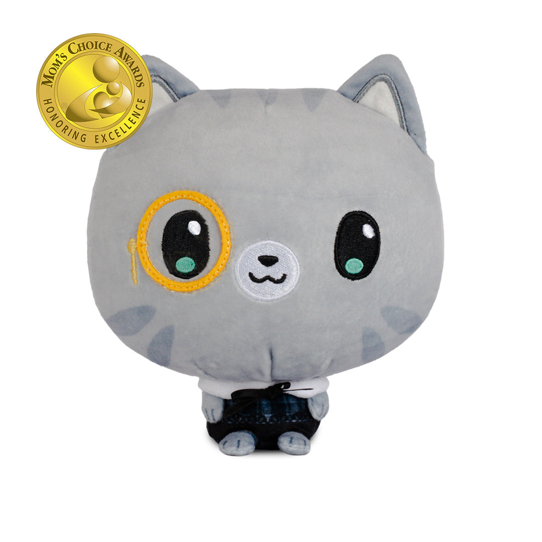 A gray plush cat toy with large embroidered eyes, one wearing a yellow monocle, standing in black pants. 
