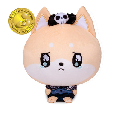 A cute plush toy of a crying Shiba Inu dog with peach-colored fur, large teary eyes, and a sad expression. It wears a black and white skull-and-crossbones headband and a dark blue patterned shirt.