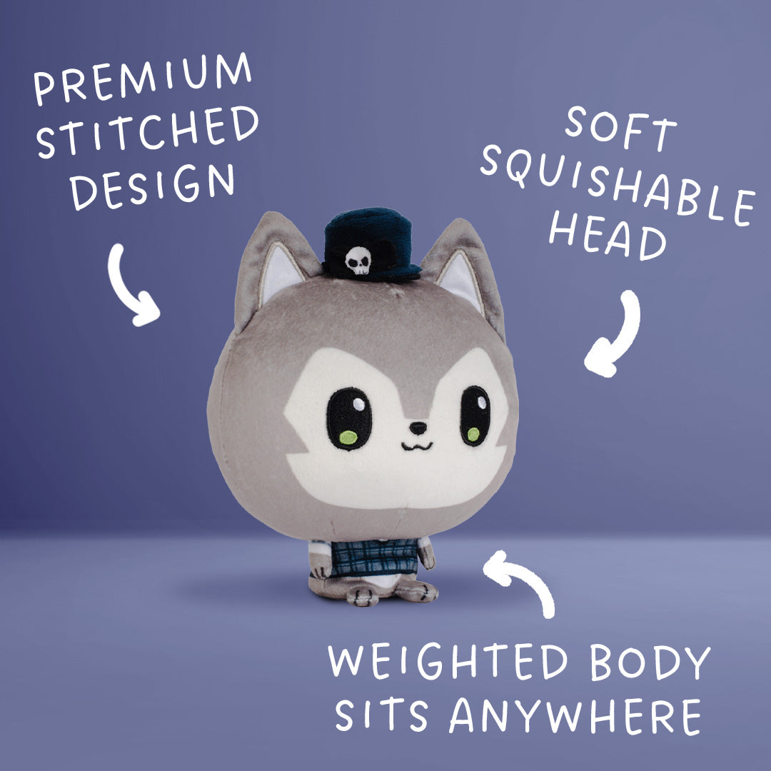 A plush toy character with a gray and wolf, large black eyes, a small black hat with a skull, and a plaid outfit, shown on a blue gradient background with white text callouts describing features.