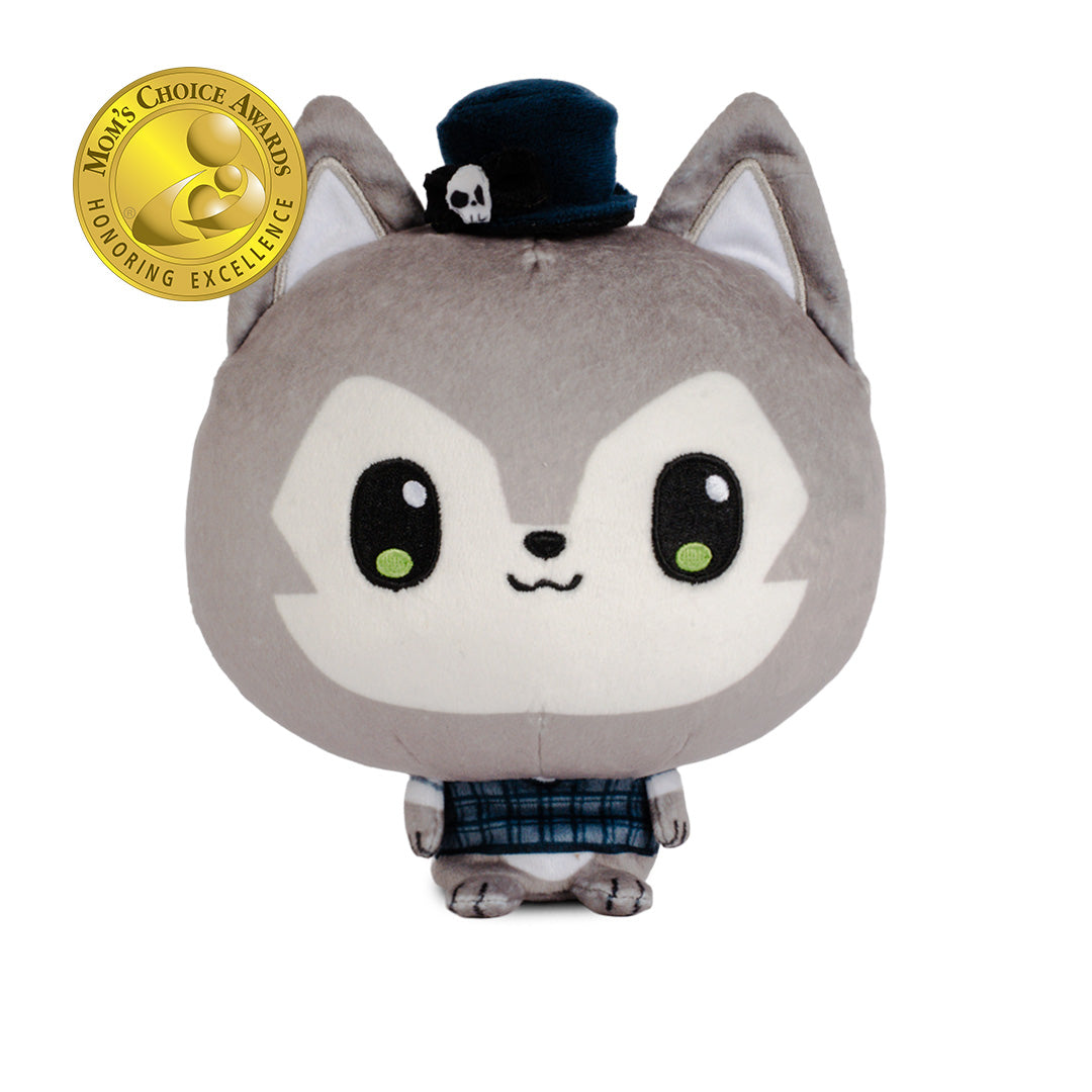 A plush toy of a cute gray and white cartoon wolf wearing a small black top hat with a white skull detail and a blue plaid shirt. 