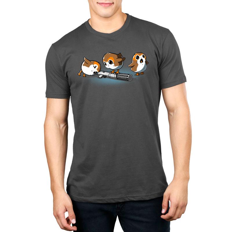A man wearing an officially licensed Star Wars Curious Porgs t-shirt with two dogs on it.