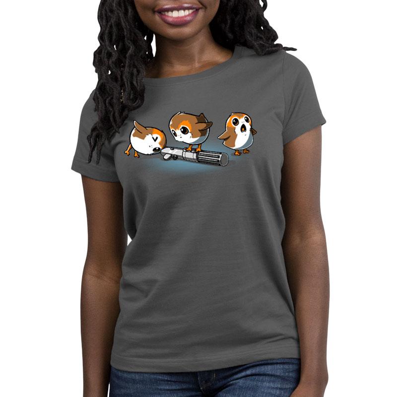 A woman wearing a gray Star Wars unisex tee with two Curious Porgs on it.