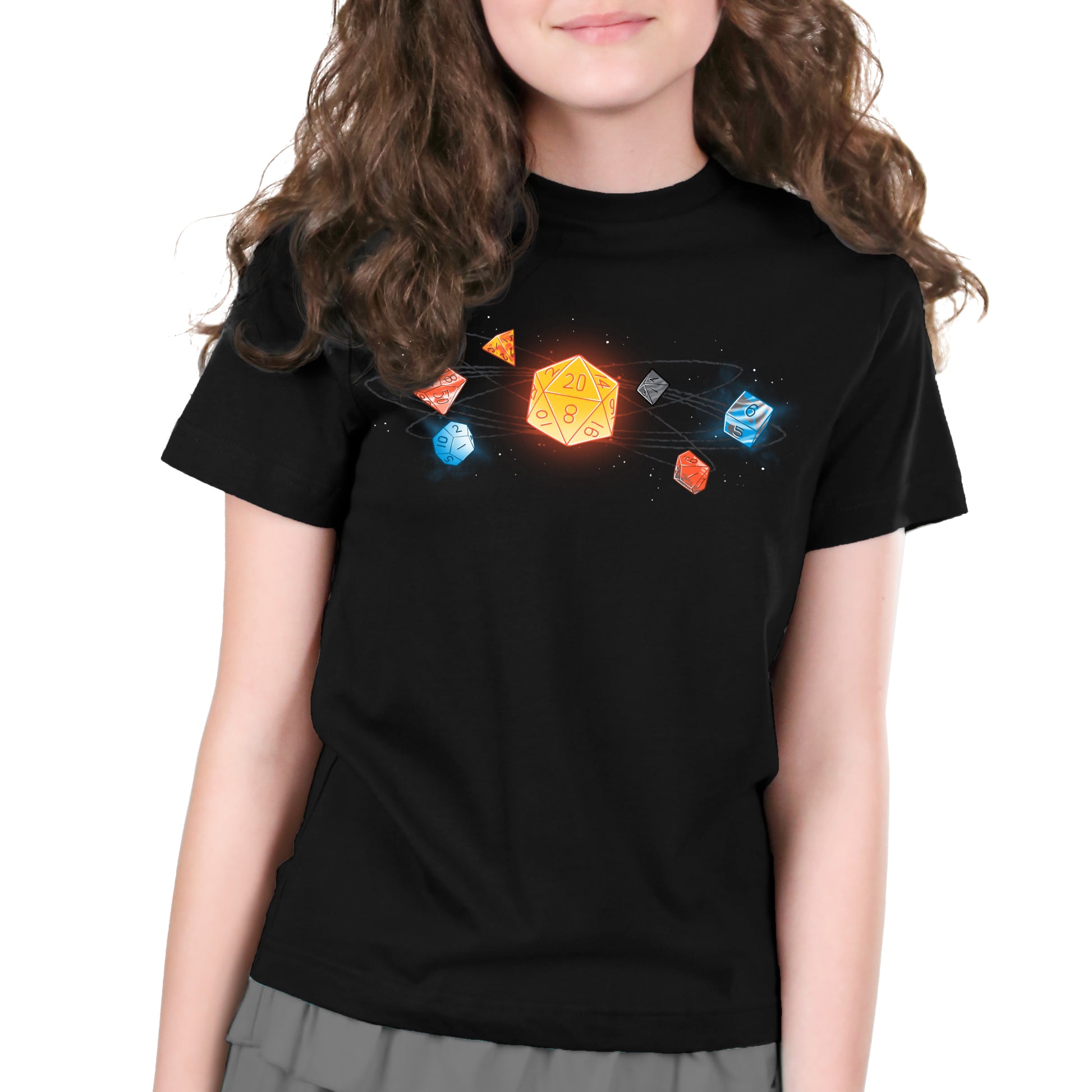 A young girl wearing a black T-shirt with an image of D20 dice from TeeTurtle.