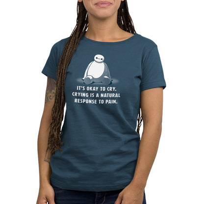 A woman wearing an officially licensed "It's Okay To Cry" women's t-shirt featuring Baymax from Disney.