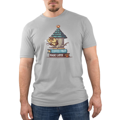 A man wearing a grey Coffee First, Magic Later T-shirt from Disney.