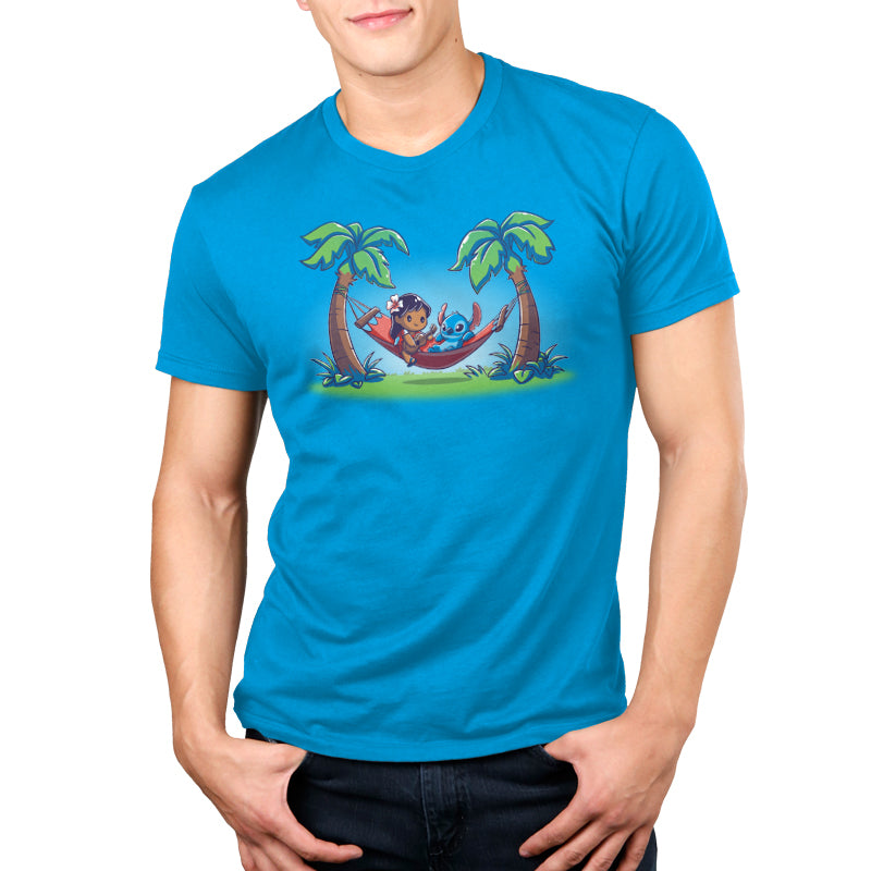 A man wearing an officially licensed Disney Lilo and Stitch t-shirt with palm trees and a hammock.