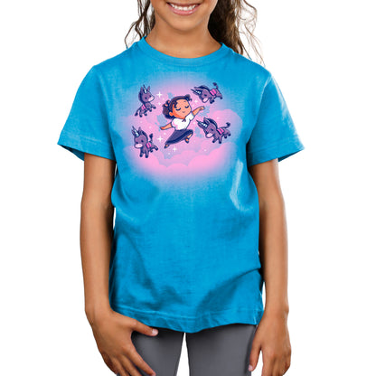A girl wearing a cobalt blue Luisa's Dream t-shirt with an image of a girl flying.