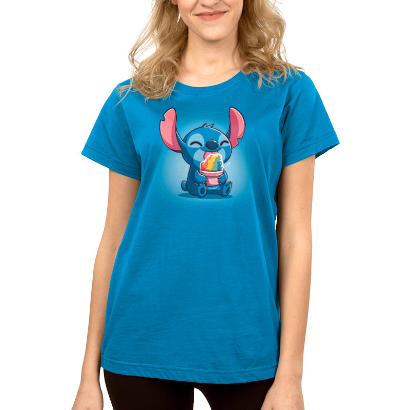 Woman wearing a super soft ringspun cotton blue t-shirt with an image of the animated character Stitch holding a snow cone, officially licensed Disney apparel.