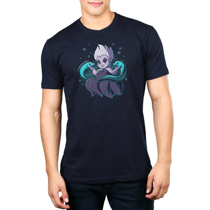 A man wearing an officially licensed Ursula & Flotsam and Jetsam blue t-shirt with an image of a unicorn.