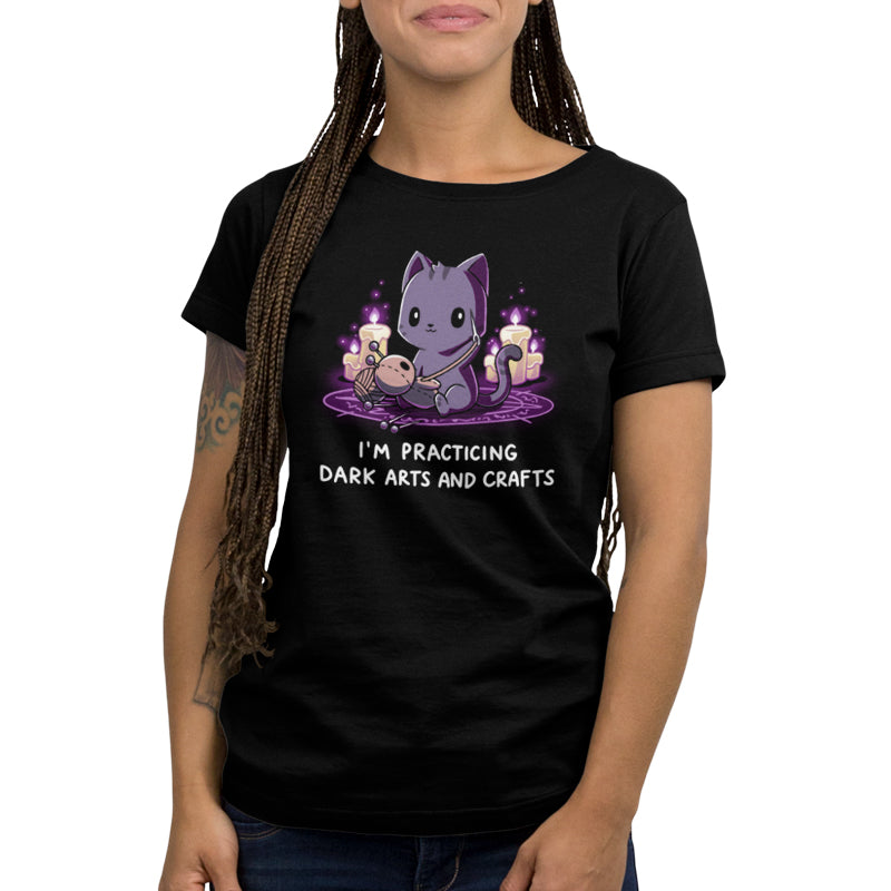 A woman wearing a TeeTurtle Dark Arts and Crafts black t-shirt.