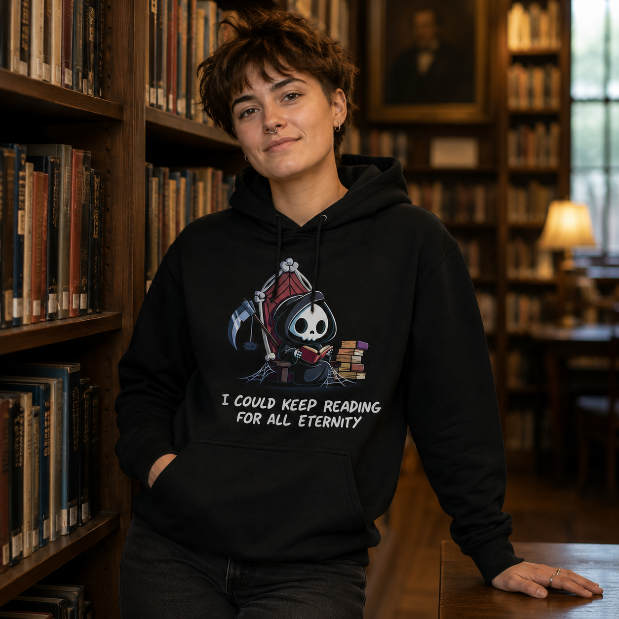 Pullover Hoodie_TeeTurtle black Eternal Reader featuring the Grim Reaper on a cobwebbed throne reading a book with text, “I could keep reading for all eternity“.