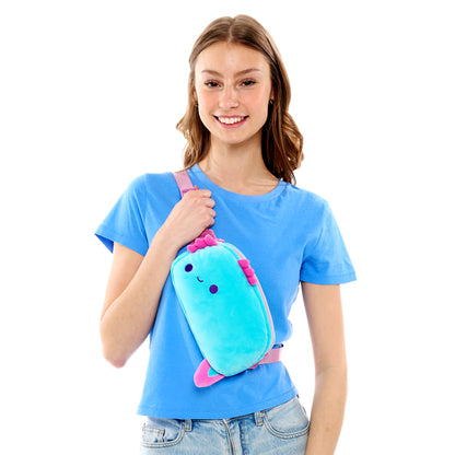 Young woman smiling while holding a Plushiverse Alotl Fun plushie fanny pack by TeeTurtle with an adjustable belt.