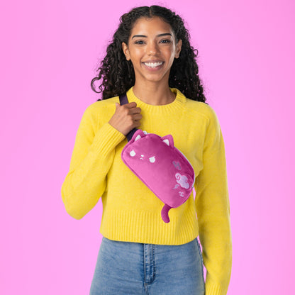 A woman wearing a yellow sweater and a TeeTurtle Plushiverse Thunder Paws Plushie Fanny Pack with an adjustable belt, perfect for festivals.