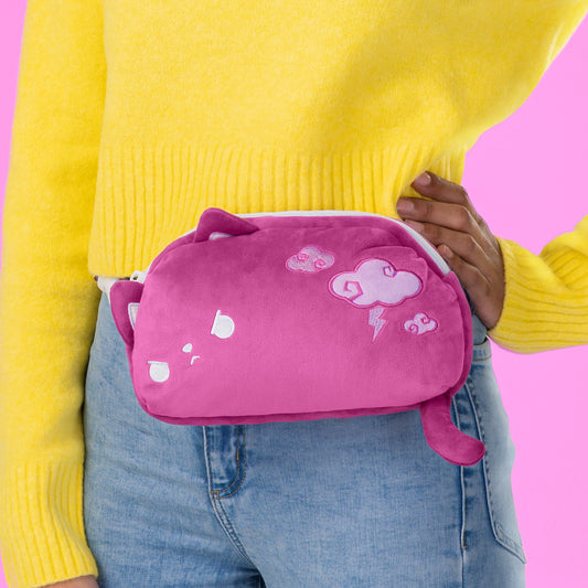 A woman is wearing a Plushiverse Thunder Paws plushie fanny pack by TeeTurtle with an adjustable belt at festivals.