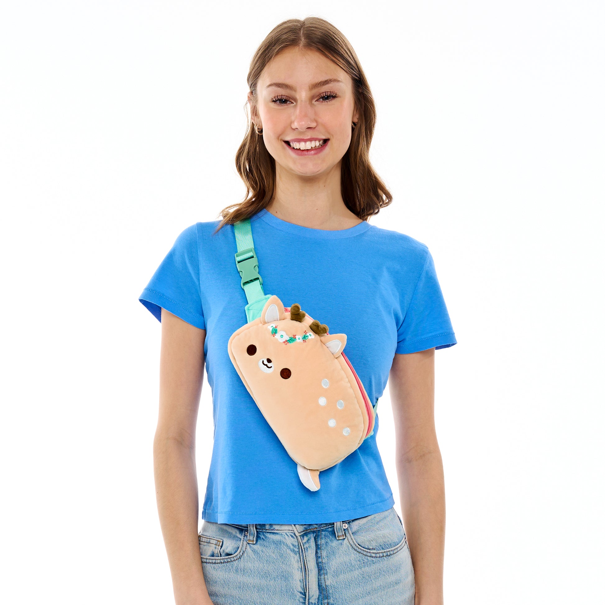 Young woman smiling with a blue shirt and a Plushiverse Flora & Fawn-a Plushie Fanny Pack from the TeeTurtle Kawaii Cuties collection.