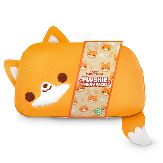 An orange Plushiverse Feeling Foxy Plushie Fanny Pack with a sleeping fox face design, an adjustable belt, and a tag displaying the product brand 