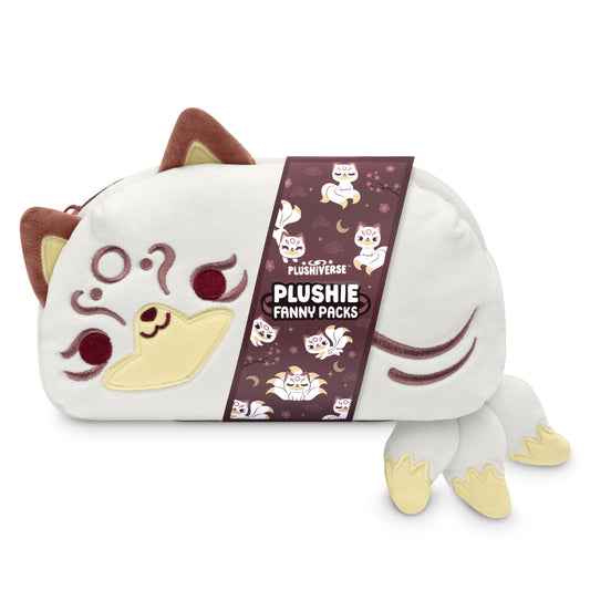 A Plushiverse Magical Kitsune Fanny Pack by TeeTurtle shaped like a cat's face with a plush tail, paws, and ears, features an adjustable belt and is displayed alongside its product tag.