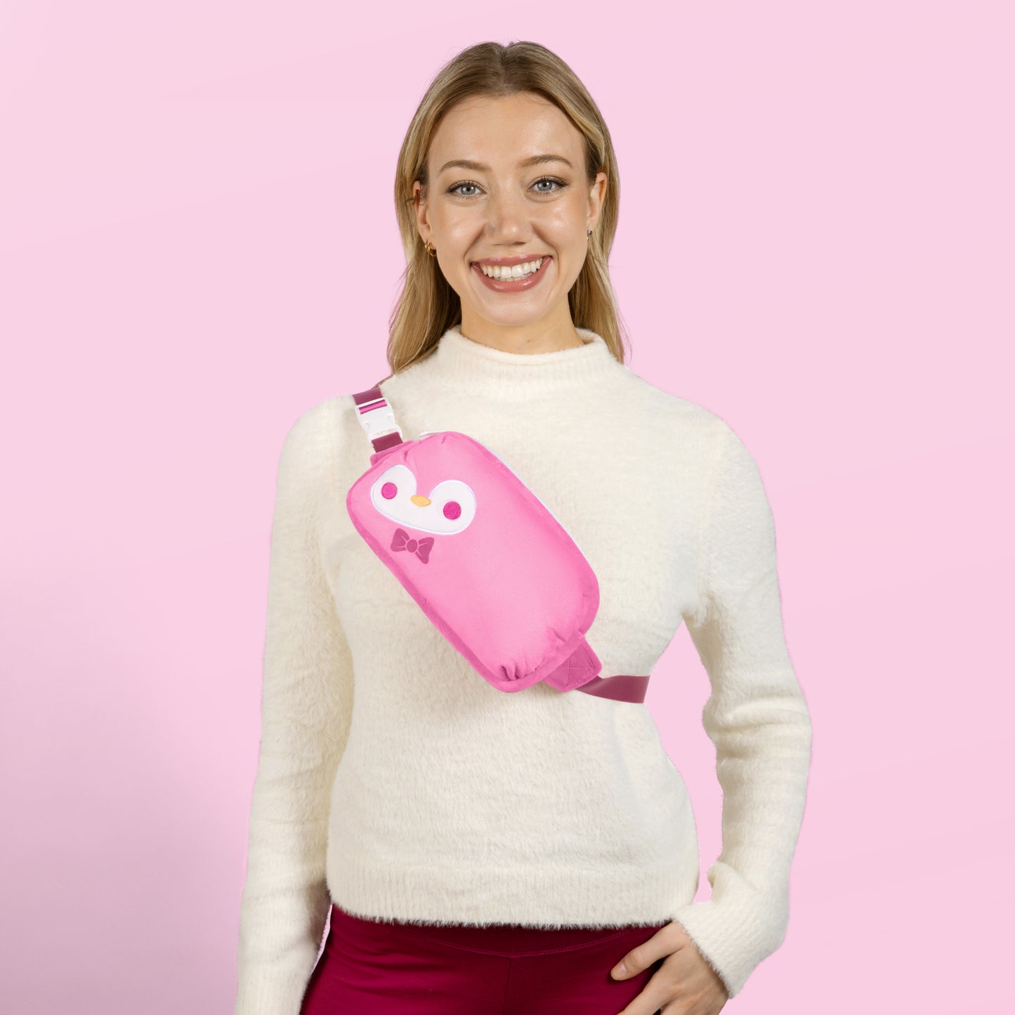 A woman wearing a TeeTurtle Plushiverse Dapper Penguin Plushie Fanny Pack, perfect for Valentine's Day.