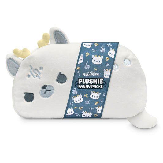 TeeTurtle's Plushiverse White Stag Fanny Pack, shaped like a cartoon cow with golden horns and blue eyes, featuring an adjustable belt and a 'plushiverse' tag attached, stands against a white background.