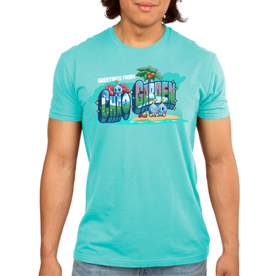 Premium Cotton T-shirt_TeeTurtle caribbean blue Greetings from Chao Garden Premium Cotton T-shirt featuring a vintage postcard design with cute little chao guys on an island with a coconut tree. There is text that reads "Greetings from" at the top and below there is a landscape visible in the bubble letters that spell "Chao Garden"