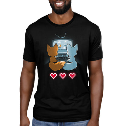 A man wearing a TeeTurtle Fur the Love of Gaming gaming t-shirt with two foxes and hearts on it.