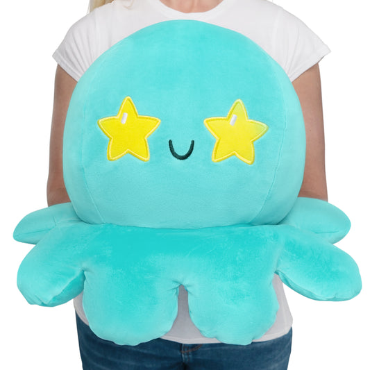 A woman cuddling a TeeTurtle Giant Moody Octopus Plushie.