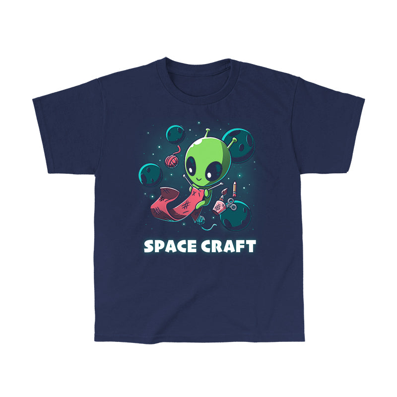 Classic Cotton T-shirt_TeeTurtle Space Craft navy blue t-shirt featuring an illustration of a green alien knitting a red scarf in space surrounded by planets, stars, balls of yarn, and a cup holding scissors, a paint brush and floating pencil. The words "SPACE CRAFT" are written below.