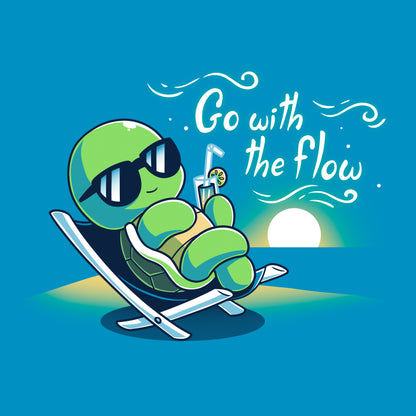 Classic Cotton T-shirt_Teeturtle Go with the Flow Cobalt Blue Featuring a turtle lounging on a beach chair with a tropical drink and sunglasses as the sun sets in the distance with the words 'Go with the Flow' to one side.