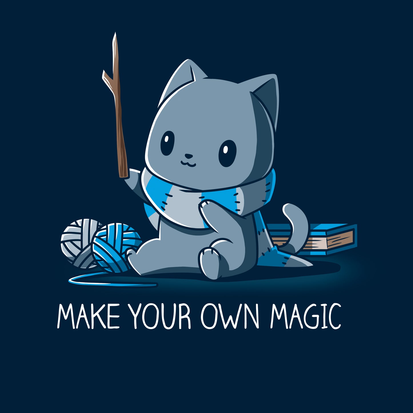 Classic Cotton T-shirt_Teeturtle Make Your Own Magic Navy Blue Featuring a gray cat sitting in front of a book next to yarn with a wand-like stick and a crafted scarf with the text 'Make Your Own Magic' below.