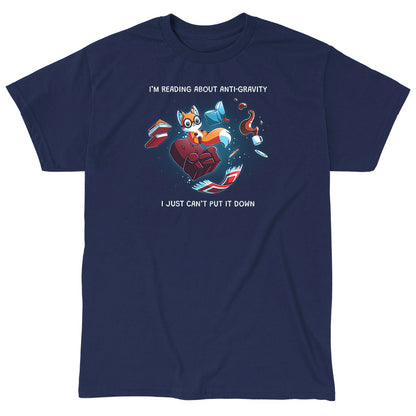 Classic Cotton T-shirt_TeeTurtle navy blue Anti-Gravity Enthusiast apparel featuring a fox wearing glasses reading a book with floating in mid-air with its living room furniture, such as a chair, rug, and lamp, with the caption, “I’m Reading About Anti-Gravity, I Just Can’t Put It Down“.