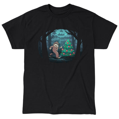 Classic Cotton T-shirt_TeeTurtle black Bigfoot Christmas apparel featuring a sasquatch caught putting holiday decor on a tree in the middle of a snowy forest.