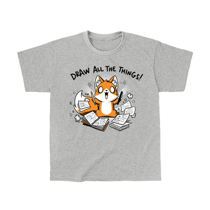 Classic Cotton T-shirt_A cartoon fox enthusiastically holding drawing tools, surrounded by sketchbooks with various drawings. Text above reads "Draw All The Things!" This monsterdigital original Draw all the Things! is crafted from super soft ringspun cotton for ultimate comfort.