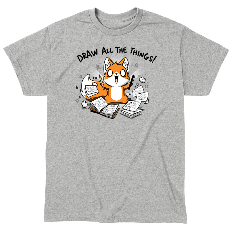 Classic Cotton T-shirt_A cartoon fox enthusiastically holding drawing tools, surrounded by sketchbooks with various drawings. Text above reads "Draw All The Things!" This monsterdigital original Draw all the Things! is crafted from super soft ringspun cotton for ultimate comfort.