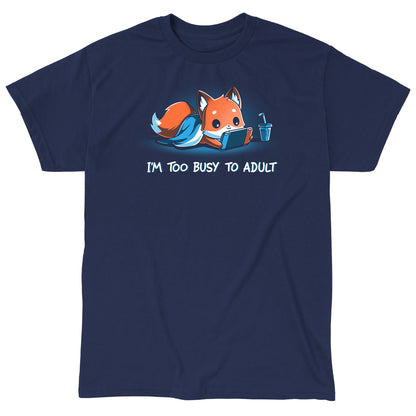 Classic Cotton T-shirt_TeeTurtle I'm Too Busy to Adult navy blue t-shirt featuring a fox lying down with a blue blanket, holding a video game tablet, next to a drink with a straw. Text below reads, "I'M TOO BUSY TO ADULT." 