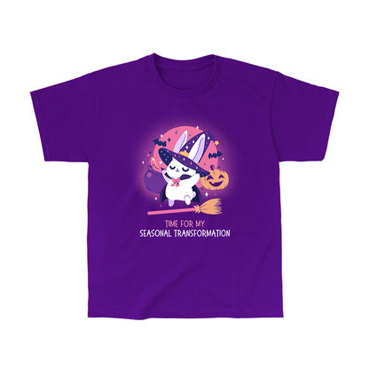 Classic Cotton T-shirt_TeeTurtle purple Time For My Seasonal Transformation apparel featuring a white bunny wearing a sparkling purple witch hat and cloak on top of a flying broom with a cauldron, bats, jack-o'-lantern, and the full red moon in the background.