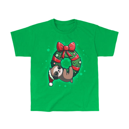 Classic Cotton T-shirt_TeeTurtle We Wish You a Lazy Christmas Irish green t-shirt featuring a cartoon sloth in a Santa hat, snoozing while hanging from a festive wreath adorned with red ribbons and ornaments. 