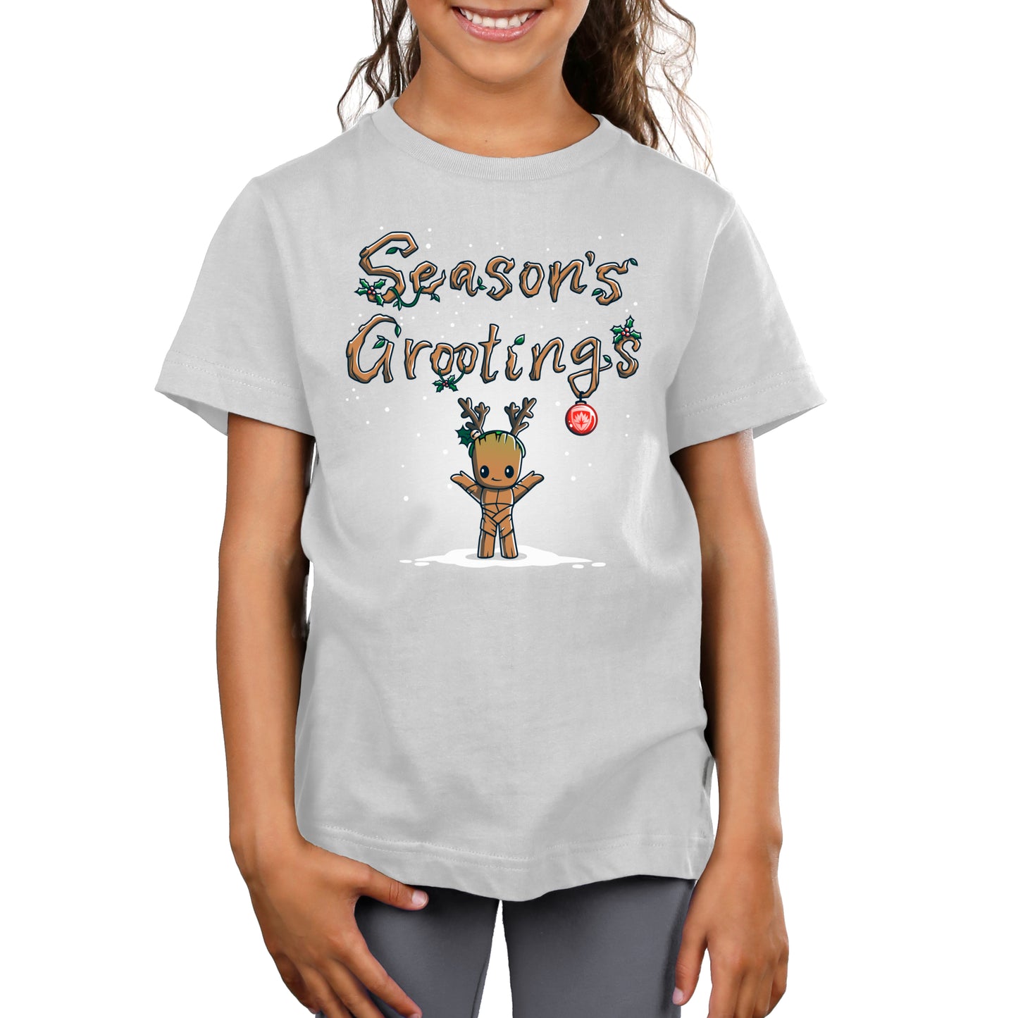 A girl wearing a t-shirt that says Marvel's Season's Grootings during the holidays.