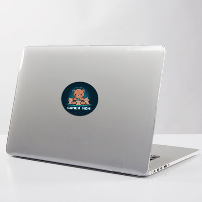 A water-resistant vinyl laptop with TeeTurtle Gamer Mom Stickers on it sitting on a table.