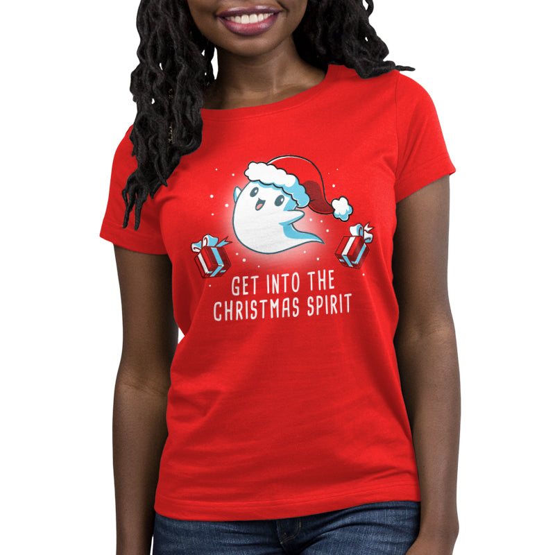 A woman wearing a red t-shirt from TeeTurtle that says "get into the Christmas spirit.