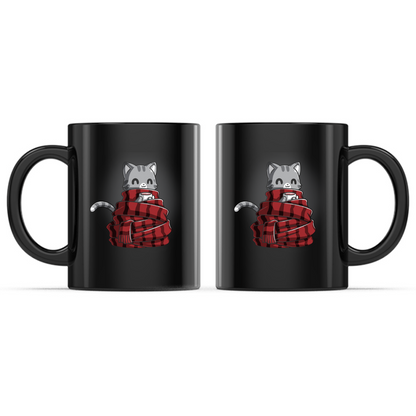 Ceramic Mug_TeeTurtle Get Cozy black mug featuring a smiling gray tabby cat wrapped in a cozy red plaid scarf while holding a warm mug.