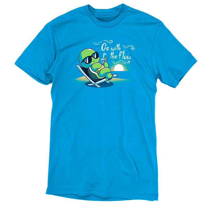 Premium Cotton T-shirt_Teeturtle Go with the Flow Cobalt Blue Featuring a turtle lounging on a beach chair with a tropical drink and sunglasses as the sun sets in the distance with the words 'Go with the Flow' to one side.