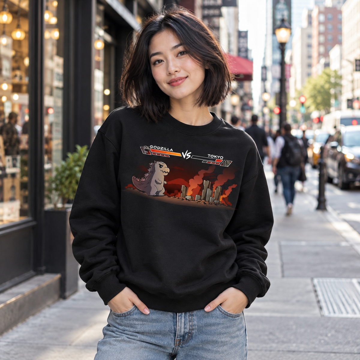Crew Neck Sweatshirt_TeeTurtle black Godzilla Fight Screen Crew Neck Sweatshirt featuring Godzilla facing a burning Tokyo skyline in a retro fighting game scene with health bars labeled "Godzilla" and "Tokyo."