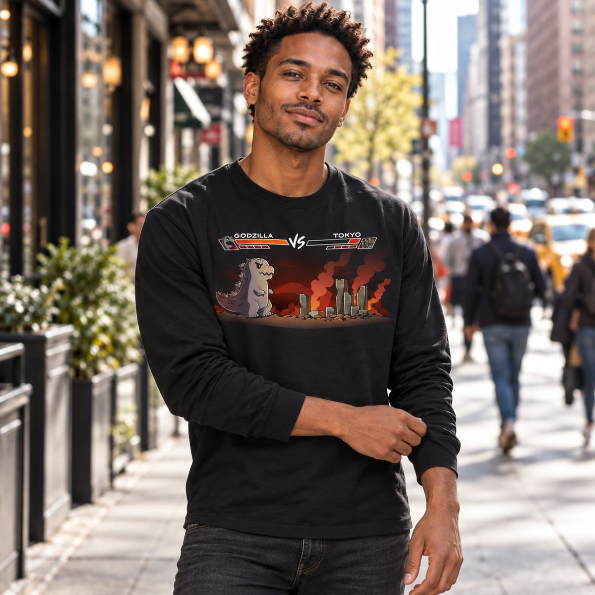 Long Sleeve T-shirt_TeeTurtle black Godzilla Fight Screen Long Sleeve T-shirt featuring Godzilla facing a burning Tokyo skyline in a retro fighting game scene with health bars labeled "Godzilla" and "Tokyo."