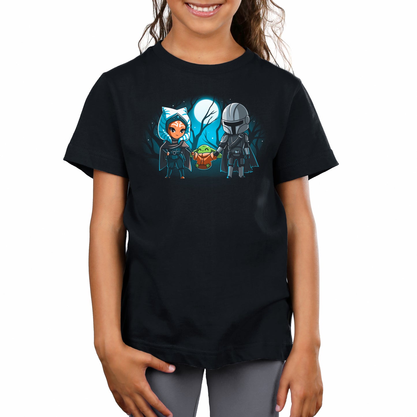 A girl wearing an officially licensed Star Wars Mandalorian t-shirt featuring Grogu's Family.