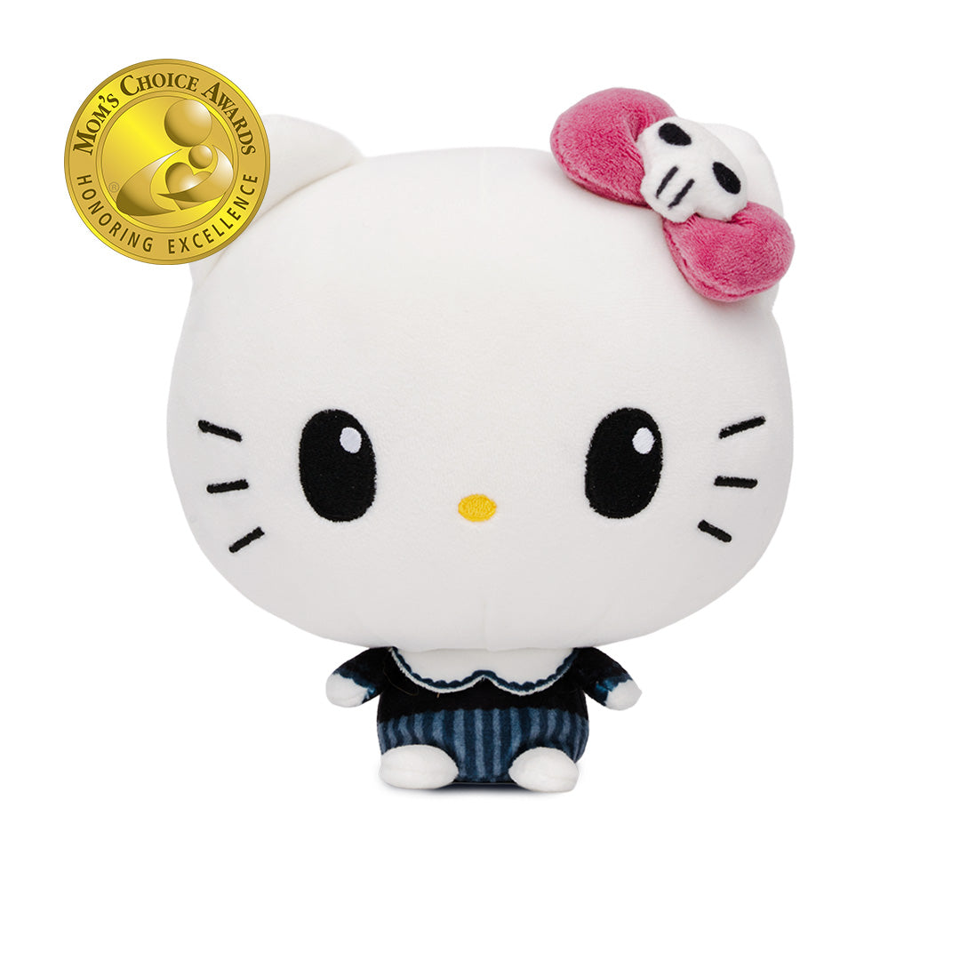 A Hello Kitty Cloudheads plushie with a large white head, black eyes, a pink bow with a skull detail, and a navy-and-white striped outfit with a fancy collar. A gold Mom's Choice Awards appears in the top left corner on a white background.