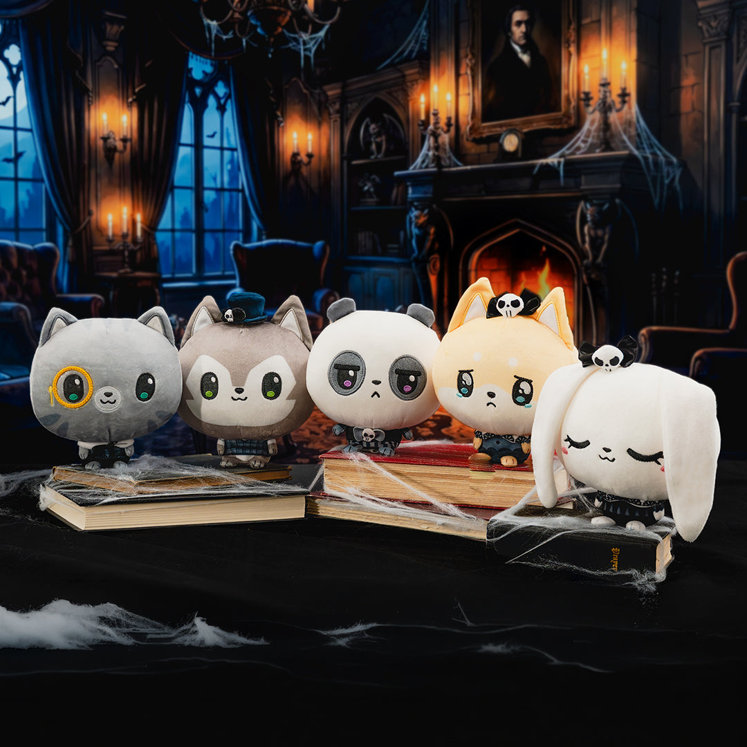 Five cute plush Cloudheads arranged on old books in a dark, gothic room setting with candles, a fireplace, and cobwebs.