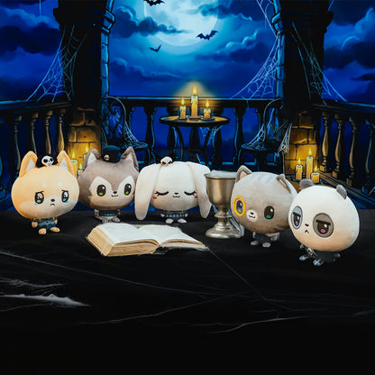 Five cute animal characters stand on a dark table in a gothic night scene with candles, bats, and a moonlit sky.
