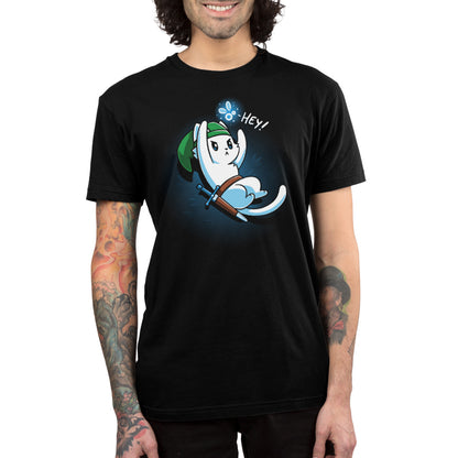 Person wearing a black monsterdigital t-shirt with a cartoon ghost character holding a sword, a green hat with the product name "Hey!", saying "Hey!" The super soft ringspun cotton fabric adds comfort, and colorful tattoos are visible on the person's arms.