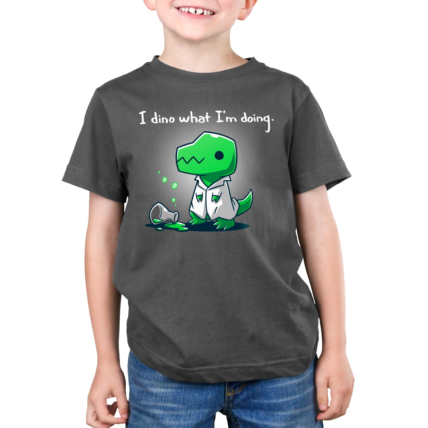A young boy demonstrating lab safety while wearing a "I Dino What I'm Doing" t-shirt from TeeTurtle.