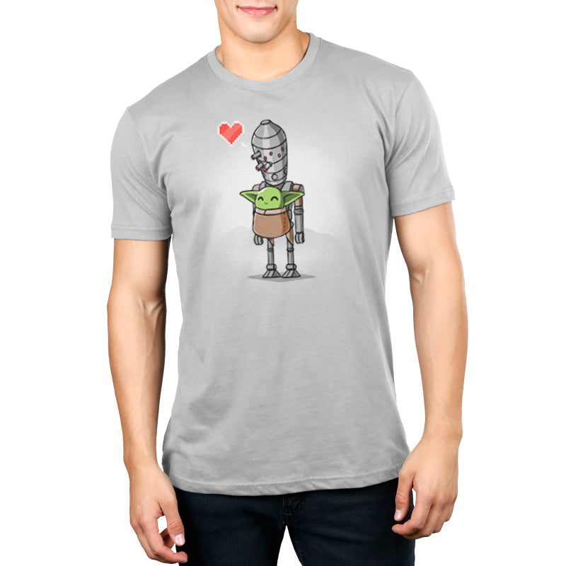 A man wearing an officially licensed Star Wars grey T-shirt with a IG-11 and The Child image holding a heart.
